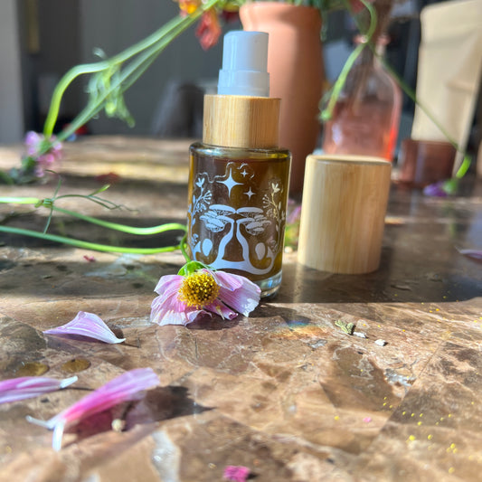 Bottle with wooden cap on a table with flowers and petals